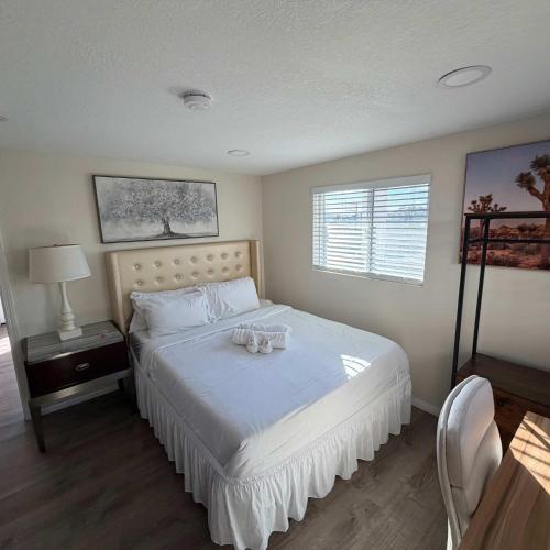 a bedroom with a bed with two glasses on it at Suite Steps to San Diego Top Spots in San Diego