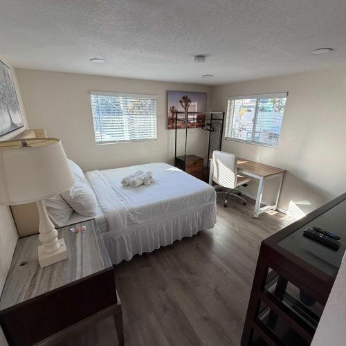 a bedroom with a bed and a desk with a desk at Suite Steps to San Diego Top Spots in San Diego