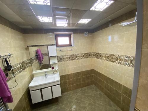 a bathroom with a sink and a shower at Qusar Villa in Uzunmeşǝ