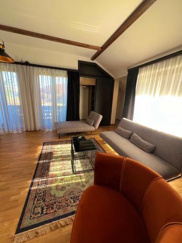 a living room with a couch and a rug at Mia's Favorite Hotel in Mavrovo