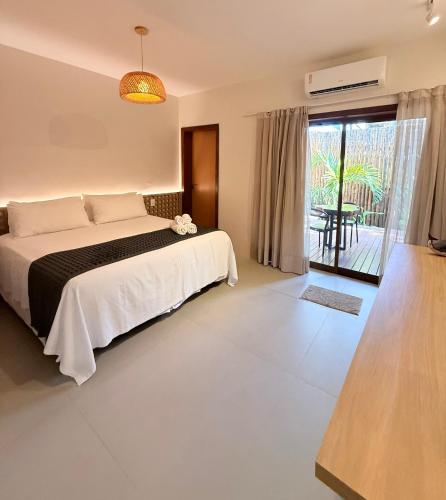 a bedroom with a bed and a view of a patio at Nari Guest Room in Fernando de Noronha