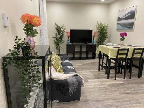 a living room with a couch and a table with a tv at Cozy stays in Montréal