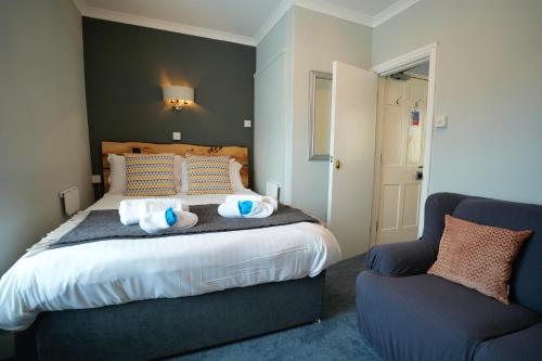 a bedroom with a bed with towels on it at Arosfa Harbourside Aberaeron in Aberaeron