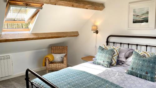 a bedroom with a bed and a chair at Ty Coets in Llanfairpwllgwyngyll
