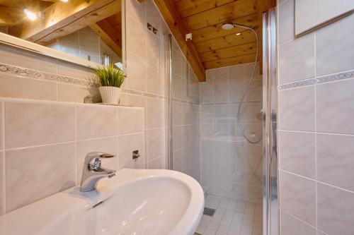 a bathroom with a sink and a shower at Bergliebe Alpspitze in Garmisch-Partenkirchen