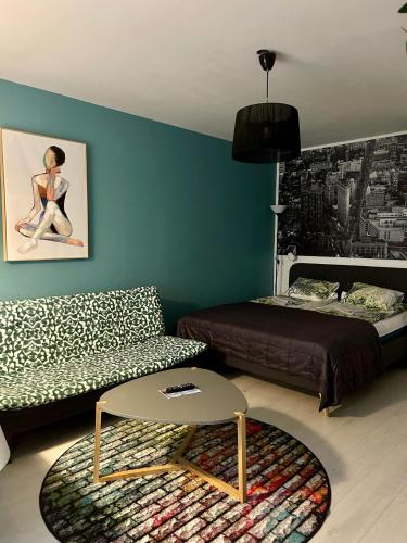 a living room with a couch and a bed at Central Studio Apartment in Pori