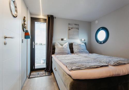 a bedroom with a large bed with a window at Uroczysko Warta in Uniejow