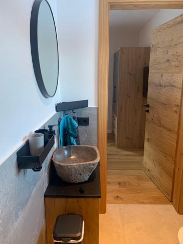 a bathroom with a bowl sink and a mirror at Ferienwohnung Heiterwang in Heiterwang