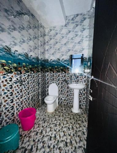 a bathroom with a toilet and a sink at The Retreat Base in Rājpur