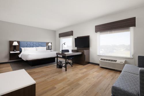 a hotel room with a bed and a desk at Hampton Inn & Suites McAllen in McAllen