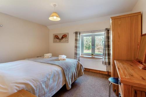 a bedroom with a bed and a window at 3 Bed in Littledean oc-g31084 in Little Dean