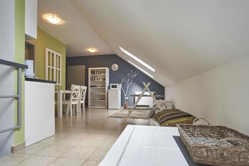 a kitchen and a living room with a table at Apartmány Pelech in Trenčianske Teplice