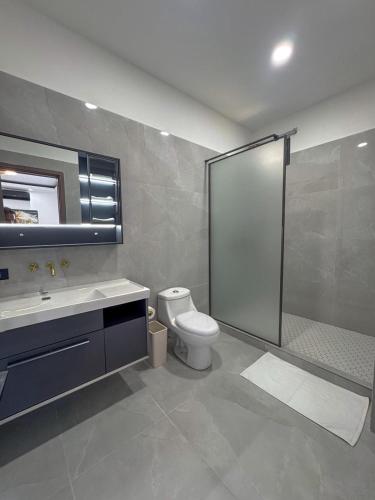 a bathroom with a toilet and a shower and a sink at TEL AVIV - Apartamentos by Luxury Atitlan in San Pedro La Laguna