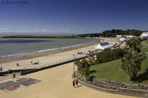 a group of people walking on a beach at 2 Bed in Cardiff oc-91126 in Cardiff