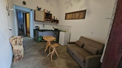 a living room with a couch and a table at Casa Corrupião - Ilha do Ferro - Alagoas in Pão de Açúcar