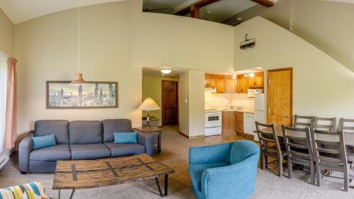 a living room with a couch and a table and a kitchen at Cahilty #429 home in Sun Peaks