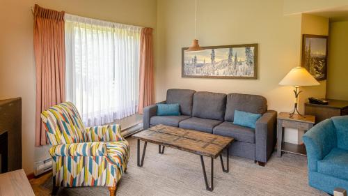 a living room with a couch and a chair at Cahilty #429 home in Sun Peaks