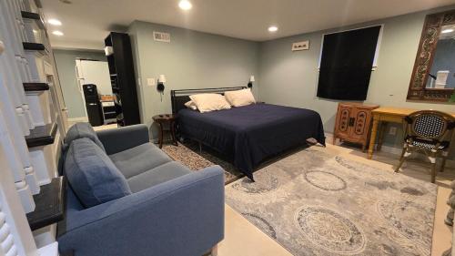 a living room with a bed and a couch at Clinker Cottage Garden Apartment - Free Breakfast! in Albany