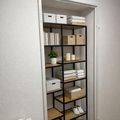 a book shelf with towels and boxes in a room at Maisonette am Burg in Möckmühl