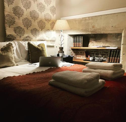 a bedroom with a bed with a laptop on it at The Chapter House in Salisbury