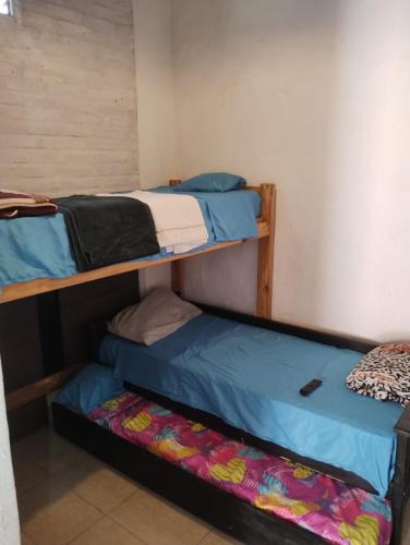 two bunk beds in a small room with a mattress at Trotamundo in Los Polvorines