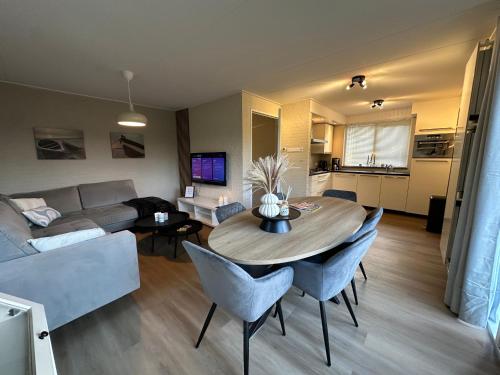 a living room with a table and a couch at Vakantiewoning Hornzicht in Anjum
