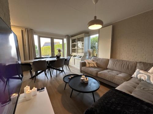 a living room with a couch and a table at Vakantiewoning Hornzicht in Anjum