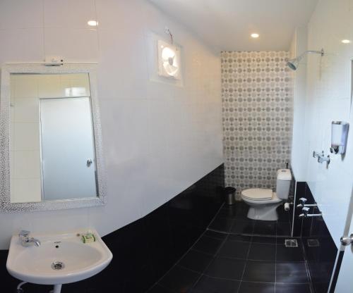 a bathroom with a sink and a toilet at Vilasam in Mahabalipuram