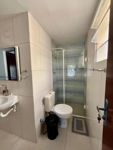 a bathroom with a toilet and a sink at Cantinho 108 in São Luís