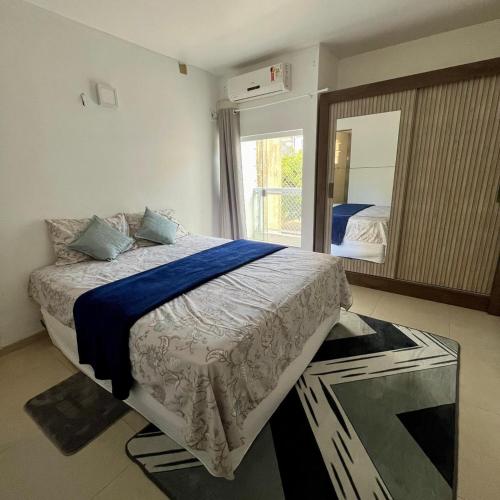a bedroom with a bed and a large mirror at Cantinho 108 in São Luís