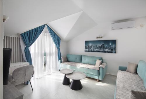 a living room with a couch and a table at Hotel Tommy in Budva