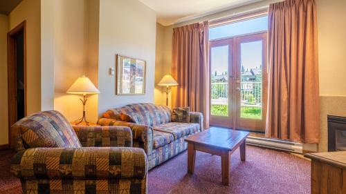 a living room with a couch and a chair at Cahilty #110 home in Sun Peaks