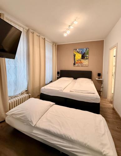 a bedroom with two beds and a window at Old Town View in Cologne