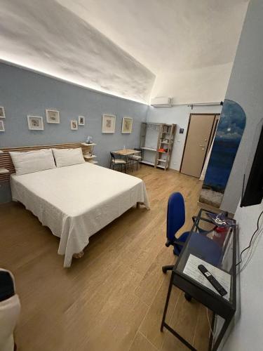 a bedroom with a bed and a table and a chair at Arthouse in Molfetta