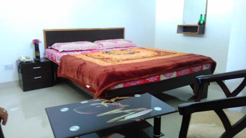 a bedroom with a bed with a table and a table at Lake face in Udaipur