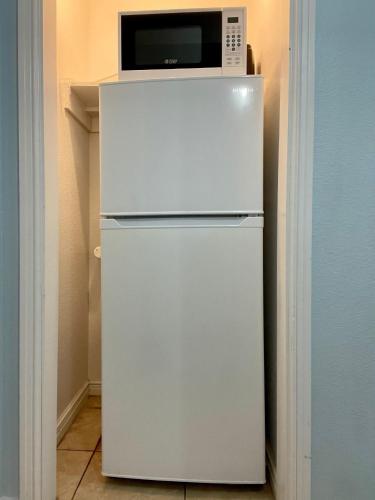 a white refrigerator with a microwave on top of it at Beachgate Condo Suites and Hotel 537a condo in Port Aransas