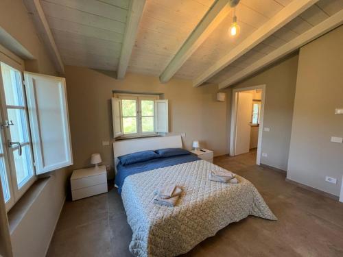a bedroom with a bed with two towels on it at IL COLLE rooms in Lucca
