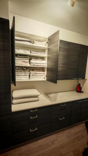a kitchen with black cabinets and white counter tops at SEA - 3 Bedrooms in Kristinestad