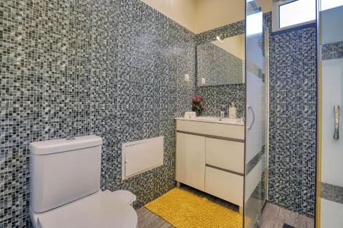 a bathroom with a toilet and a sink and a shower at Vilamar- Madeira Inn Group in Calheta