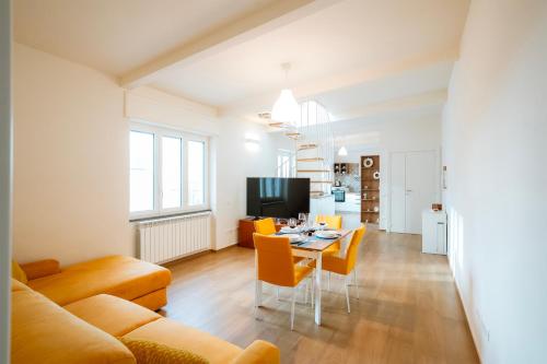 a living room with a couch and a table with chairs at Sunset Terrace Sorrento Coast in Sant'Agnello