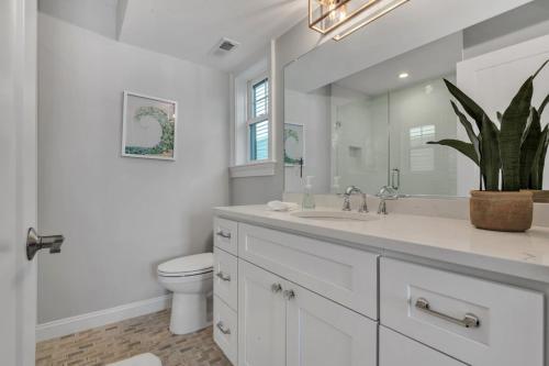 a bathroom with a sink and a toilet and a mirror at 1220 A Asbury in Ocean City