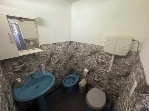 a bathroom with a blue sink and a toilet at Apartamento Lomas de Solymar in Ciudad de la Costa