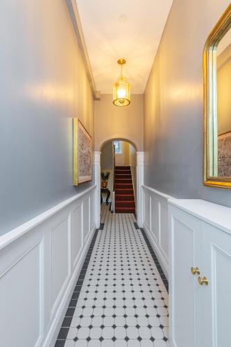 a hallway with a black and white tiled floor at Ha'penny View House in Dublin