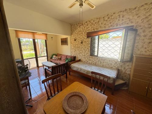 a living room with a table and a couch at Apartamento Lomas de Solymar in Ciudad de la Costa