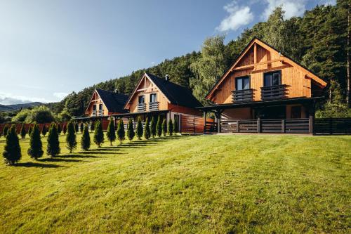 a house with a row of trees in front of it at Chaty ForRest in Stará Turá