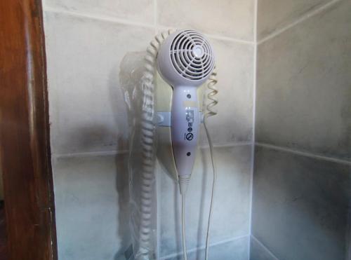a hair dryer is hanging on a wall at Taiquen Apart Hotel in San Martín de los Andes