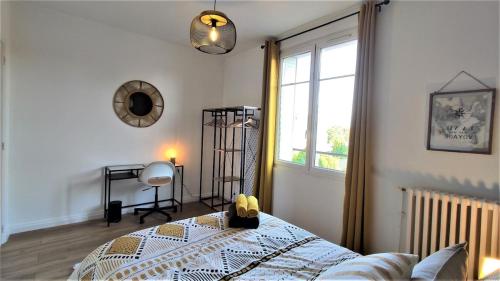 a bedroom with a bed and a window at Le Petit Jacobin - City center in Beauvais