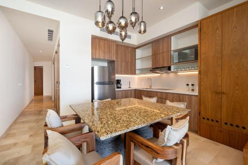 a kitchen with a large island with wooden cabinets at Zantamar TH05B, oceanfront in Cruz de Huanacaxtle
