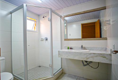 a bathroom with a sink and a shower at Meu Hotel Boituva in Boituva