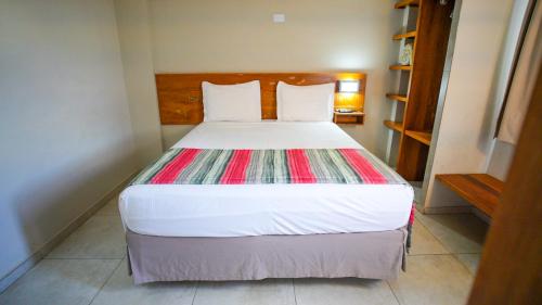 a bedroom with a large bed in a room at Meu Hotel Boituva in Boituva